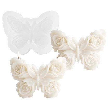 Butterfly-shaped candles with rose details on a white background