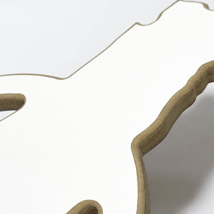 Close-up of a decorative mirror with wavy edge on a white background
