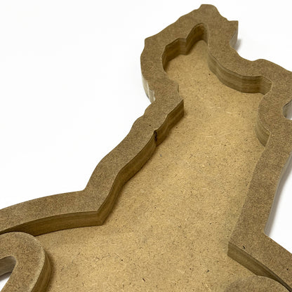 Close-up of a textured brown cardboard cutout with intricate shapes on a white background