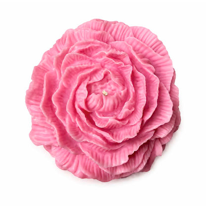 a large pink candle in the shape of a peony flower on a white background