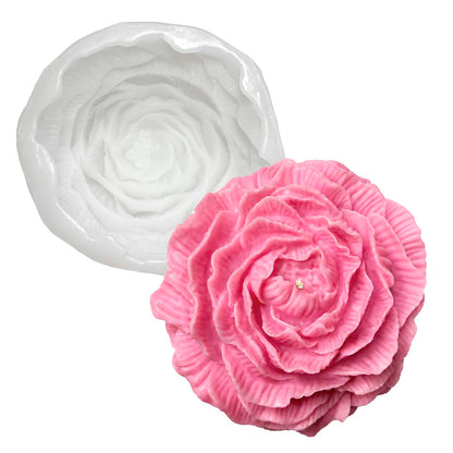 Pink rose-shaped mold next to a white rose-shaped silicone mold on a white background